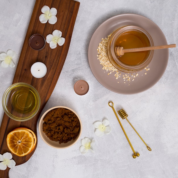 Free Photo an overhead view of herbal cosmetics products on white texture backdrop