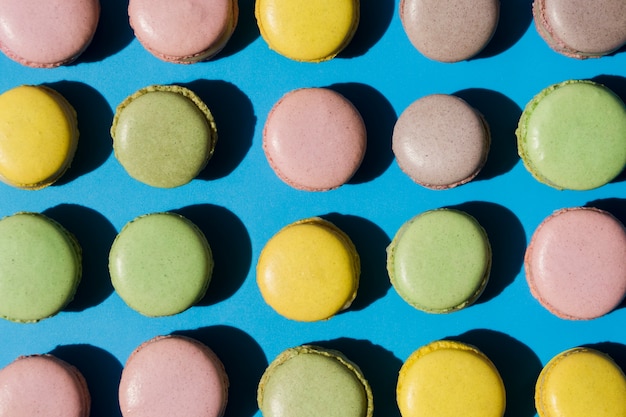 An overhead view of macaroons on blue backdrop