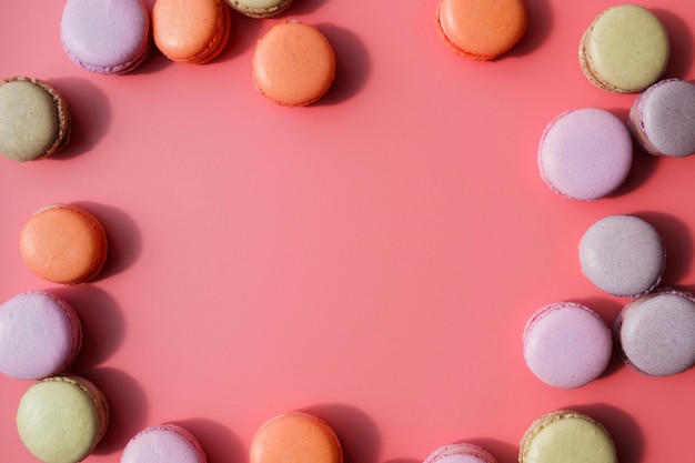 An overhead view of macaroons with copy space for writing the text on coral backdrop