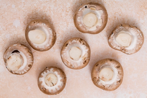 Free Photo an overhead view of mushrooms on textured background