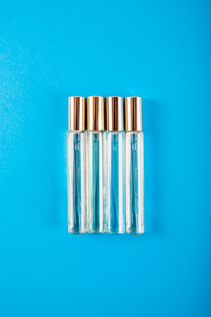 Free photo overhead view of perfume bottles on blue background