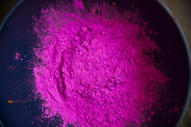 An overhead view of pink color powder inside the bowl