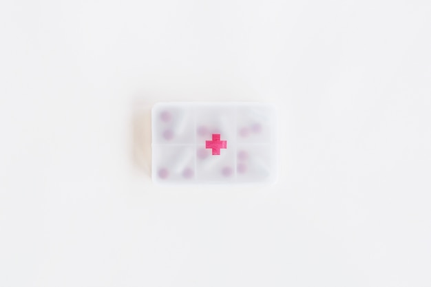 Free Photo overhead view of plastic pills container with first aid sign