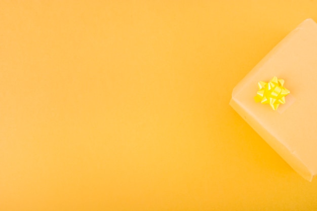 Free photo overhead view of present gift box over the yellow background