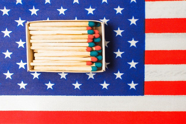 Free photo an overhead view of red and blue matchstick on american flag