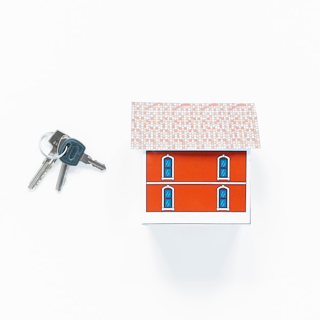 Free Photo overhead view of small house model and keys on white surface