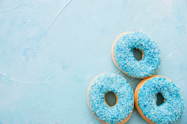 Free photo overhead view of tasty blue donuts