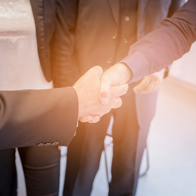 Free photo an overhead view of two businessman shaking hands together