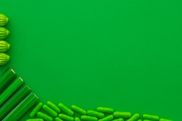 Free Photo overhead view of various sweet candies on green backdrop