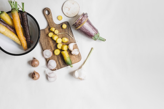 An overhead view of vegetables on white background