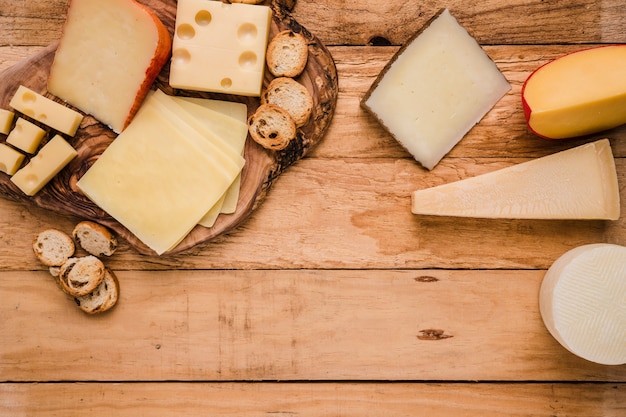 Overhead view of vivid fresh cheese arranged over wooden surface