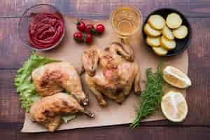 Free photo overhead view of whole chicken and leg for dinner on desk