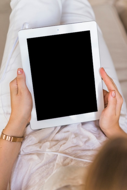 Overhead view of woman holding digital tablet with blank screen