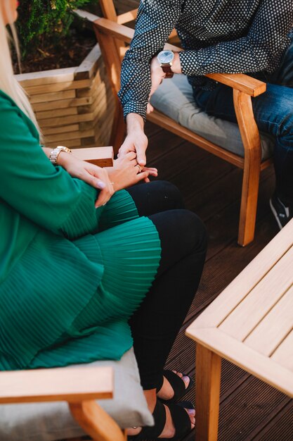 Overhead view of young couple sitting in restaurant holding each other's hand