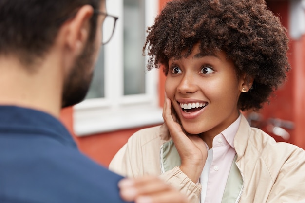 Free photo overjoyed woman receives unexpected pleasant news