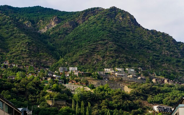 Overlooking view of buildings in a green mountain with a gloomy sky