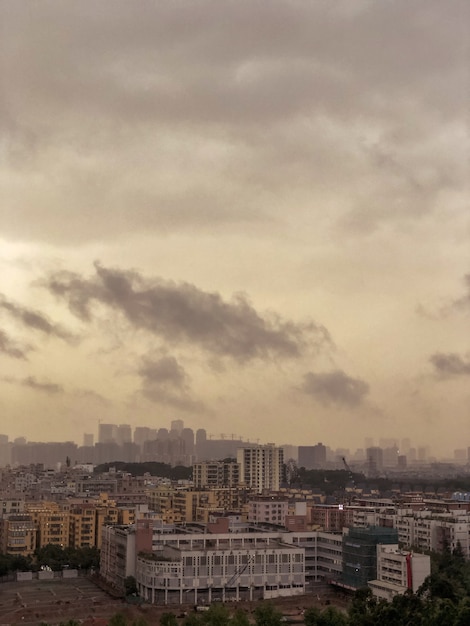 Overlooking view of an urban city full of buildings with dark clouds