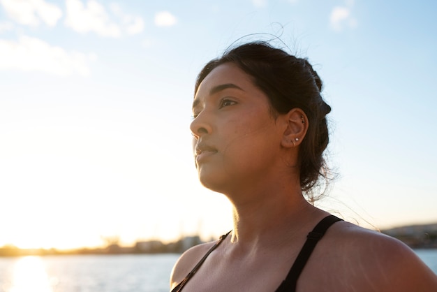 Overweight woman exercising outdoors by the lake