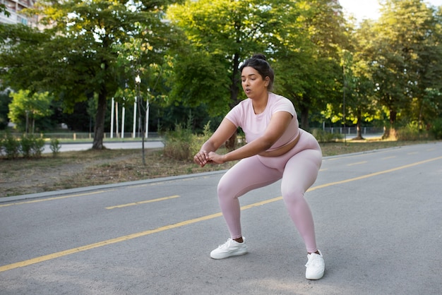 Free photo overweight woman exercising outdoors