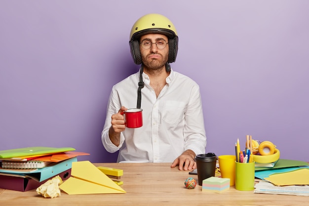 Overworked employee sitting at the office desk