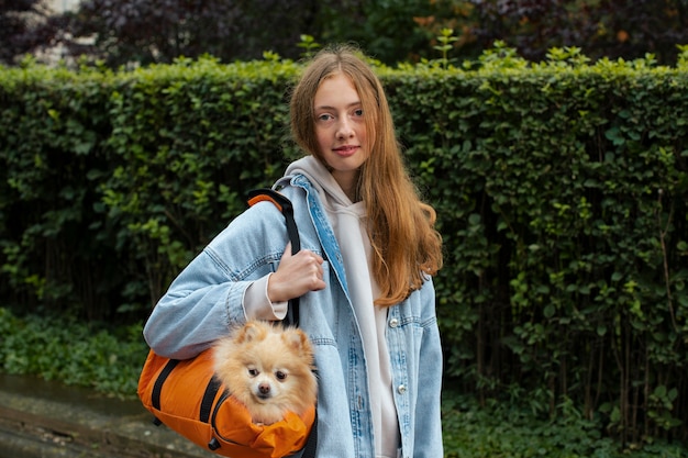 Owner holding bag with dog medium shot