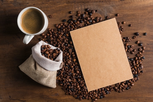 Free photo package near cup and sack with coffee beans