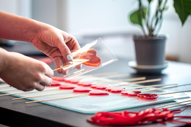 Packaging of red lollipops in the shape of hearts