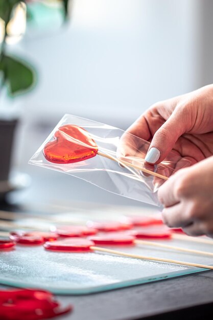 Packaging of red lollipops in the shape of hearts