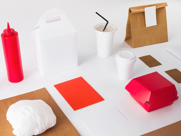 Free photo packed food with disposal cup and sauce bottle on white background