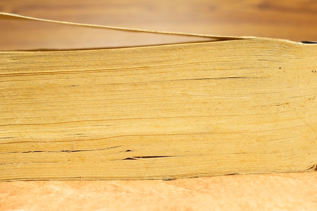 Pages of old, vintage, book pile, closeup front view with blurred background