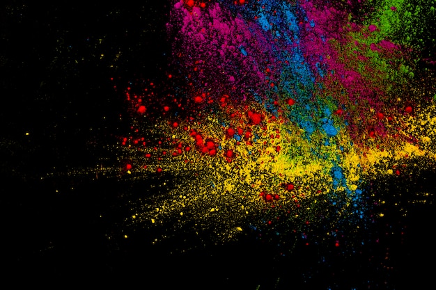 Free photo paint colorful powder explosion over dark surface