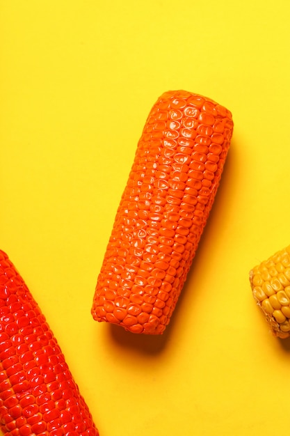 Free Photo painted corn on yellow surface