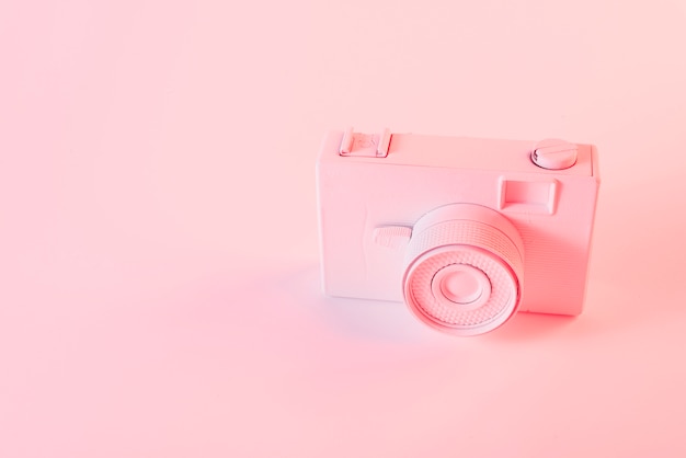 Painted pink camera against pink background