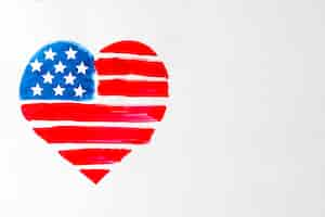 Free photo painted red and blue heart shape united states american flag on white background