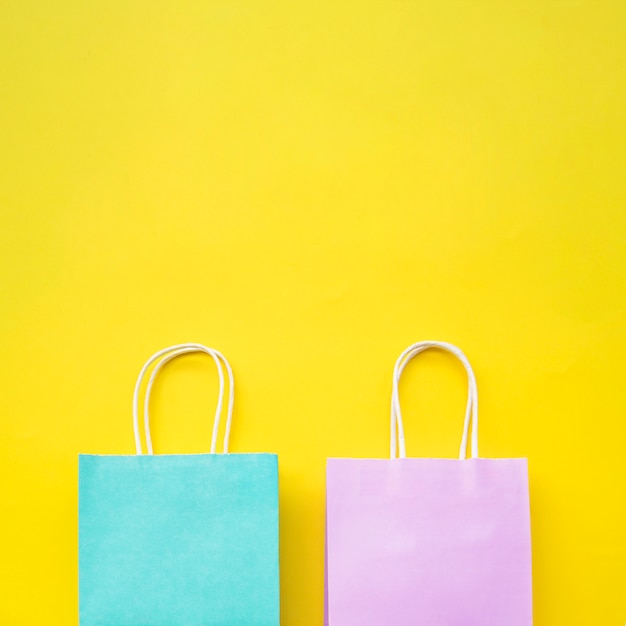 Free photo pair of pastel color paper bags