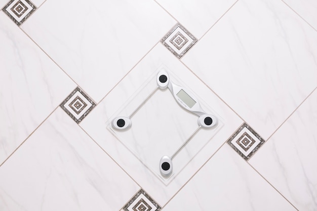 Pair of scales on bathroom floor