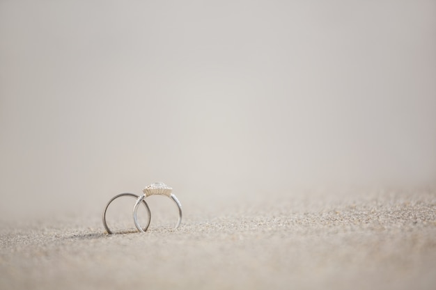 Pair of wedding ring on sand