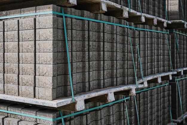 Free Photo pallets with stacked gray paving slabs selective focus stack of paving slabs in warehouse road repair or finished tile sale space for text