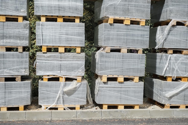 Free Photo pallets with stacked gray paving slabs selective focus stack of paving slabs in warehouse road repair or finished tile sale space for text