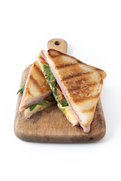 Panini sandwich with ham cheese tomato and arugula isolated on white background