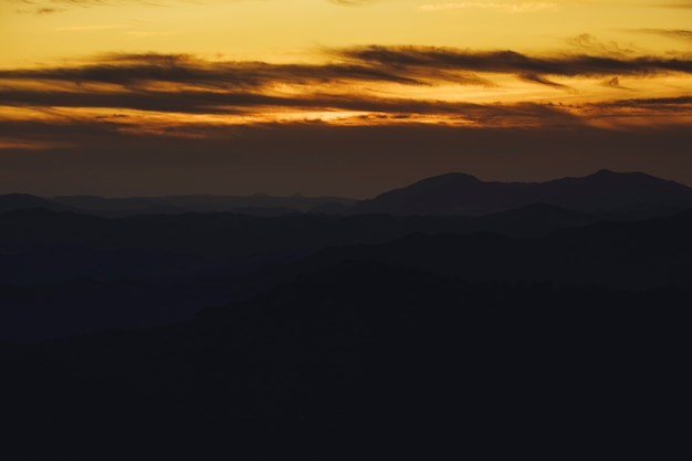 Free Photo panoramic mountain and dramatic sky sundown background in golden