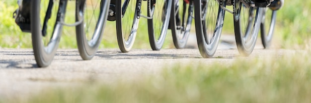 Free photo panoramic shot of  bicycle wheels riding on a ground