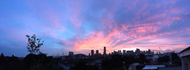 Free Photo panoramic shot of city building under a purple and blue sky