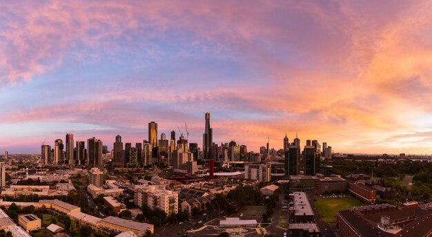 Panoramic shot of a cityscape under the beautiful orange sky during sunset