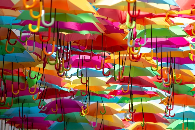 Panoramic shot of a sea of colorful hanging umbrellas