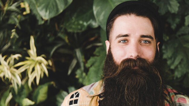 Panoramic view of bearded young man looking at camera