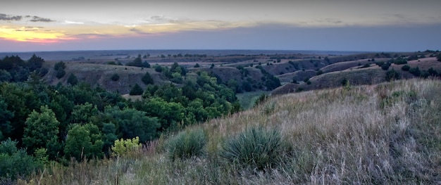 Panoramic view of a beautiful landscape with mountain ranges under the sunset sky