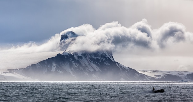 Free Photo panoramic view of an iceberg in clouds in antarctica