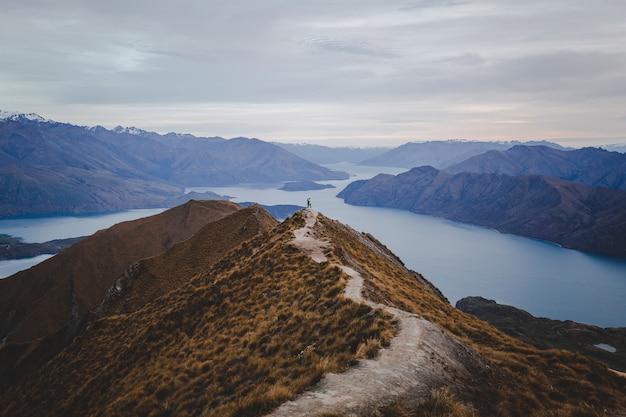 Free Photo panoramic view of the roys peak in new zealand with mountains in distance under a light cloudscape