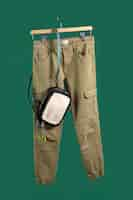 Free photo pants on hanger with green background